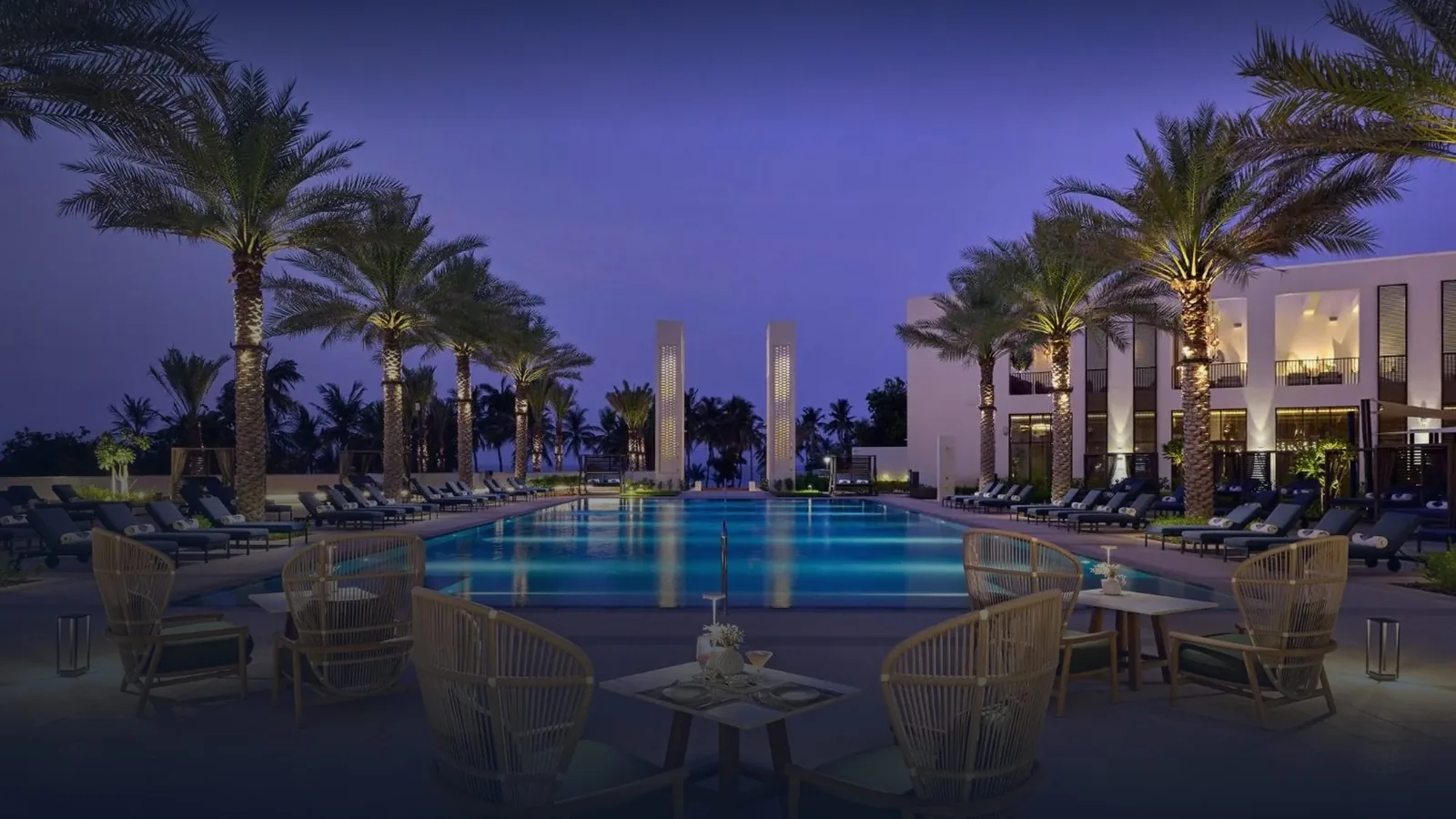 Residences pool and palm gardens at dusk, Mandarin Oriental, Muscat